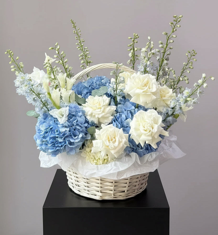 Blue delphinium and white roses basket arrangement Dubai