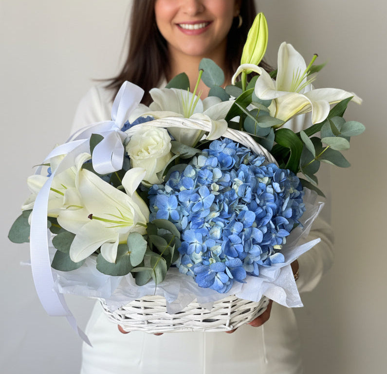 Blue hydrangeas and white lilies basket arrangement by Magic Flor Dubai