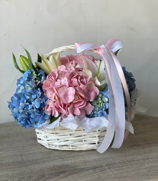 Blue and pink hydrangeas basket arrangement by Magic Flor Dubai