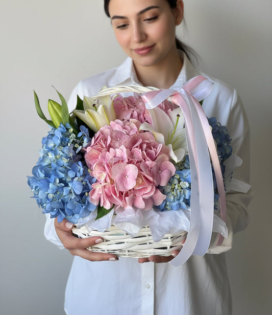 Blue and pink hydrangeas basket arrangement by Magic Flor Dubai